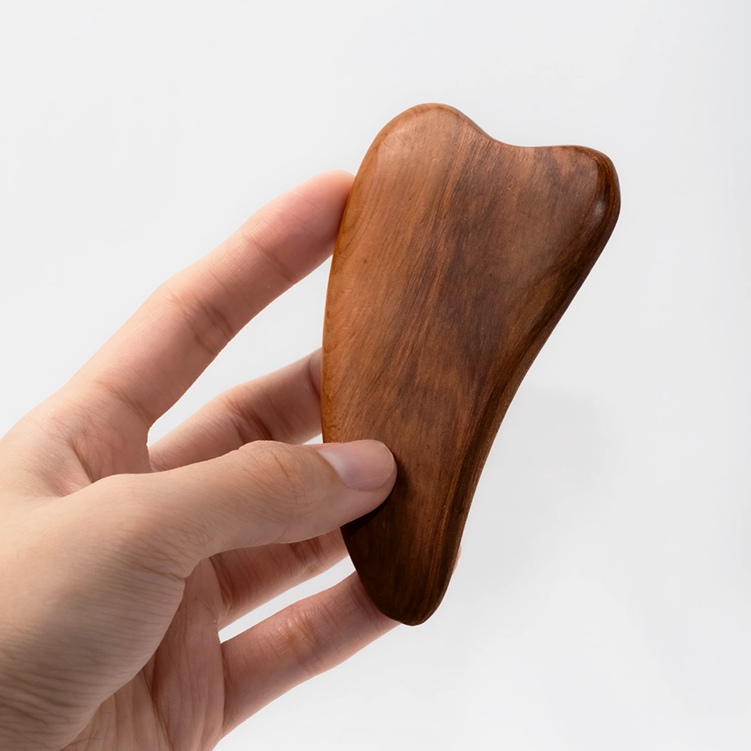 手持刮痧板示意，輕巧好拿捏，適合臉部與肩頸深層舒壓